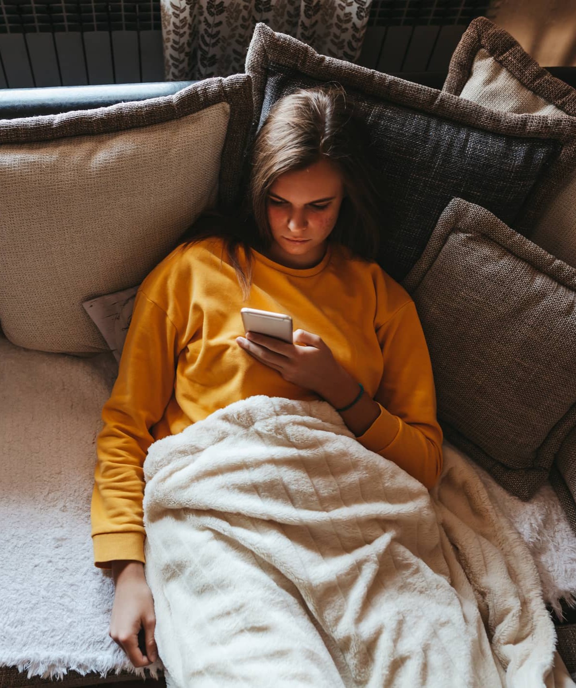 young girl scrolling through phone